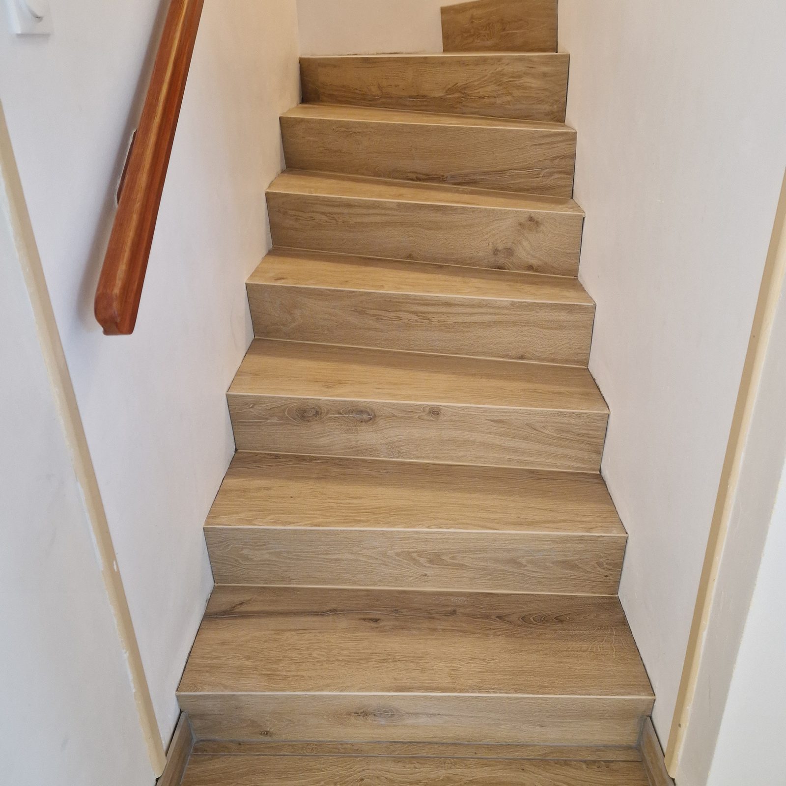 Escalier carrelé avec pose en biseau effet bois, sans baguette de finition, finition propre